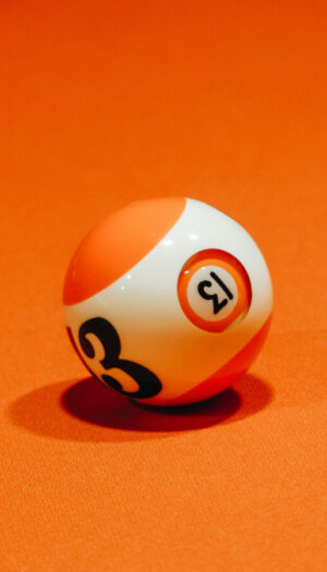 Billiard ball on bright orange surface